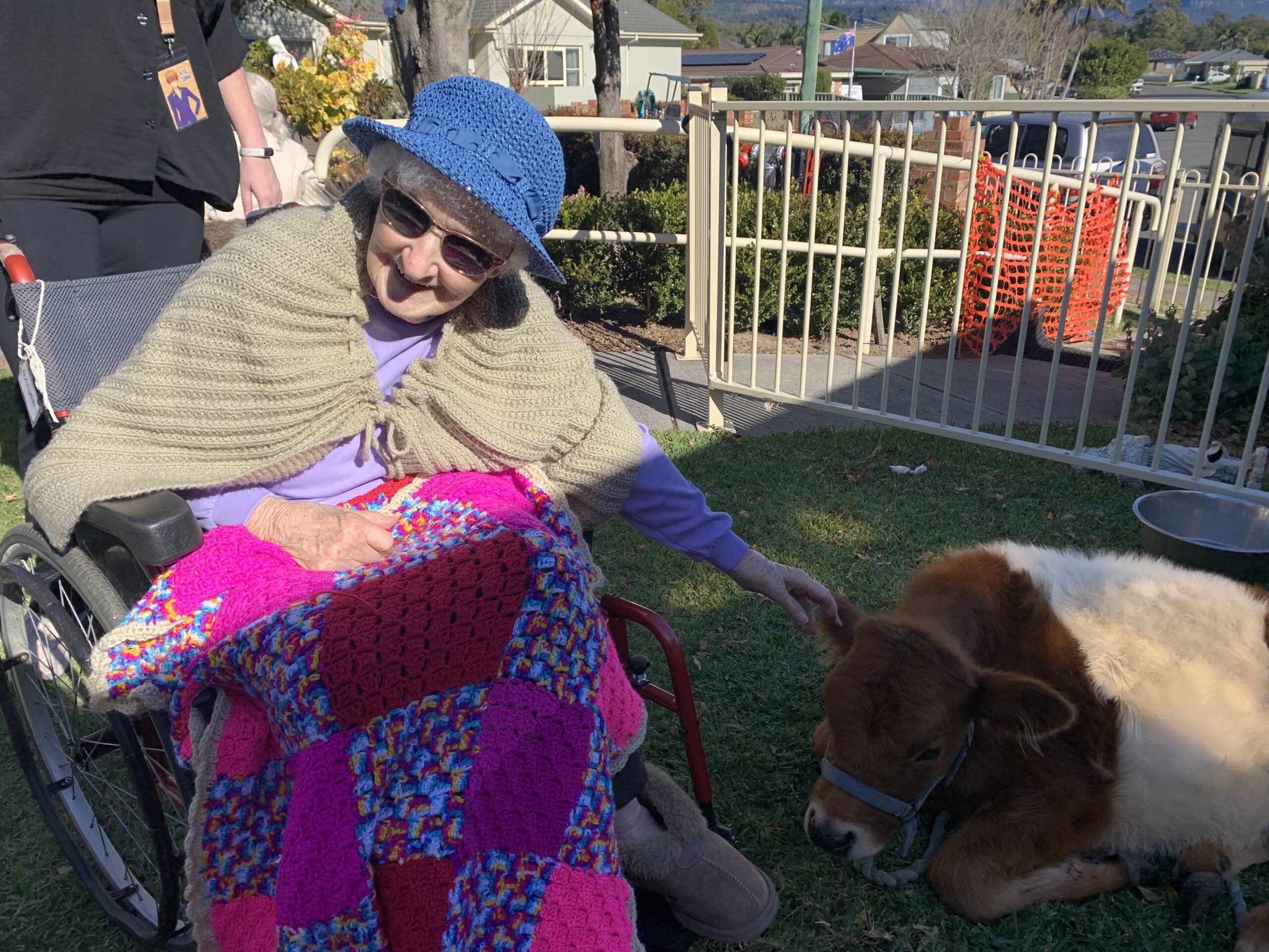 Therapy session with a happy resident and a therapy pet.