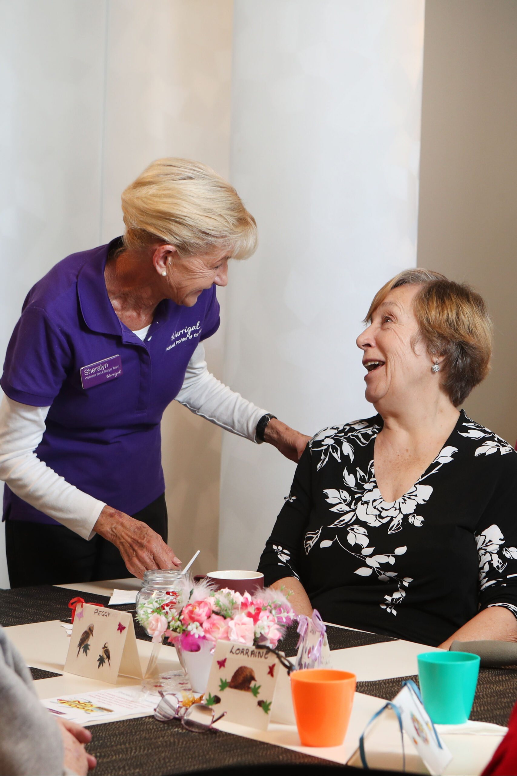 Friendly interaction between a Warrigal staff member and a resident.