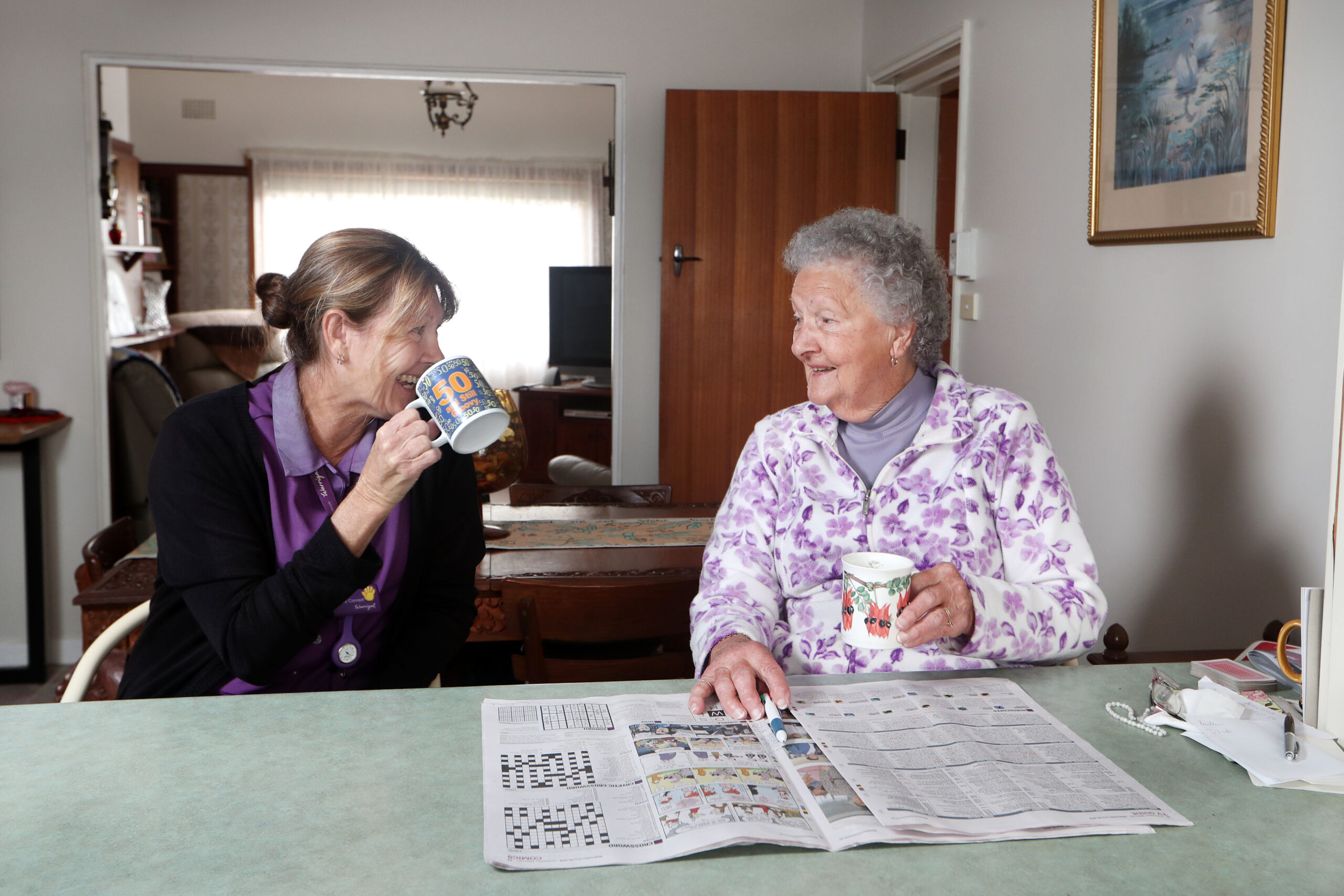 Home services staff sharing a friendly tea time with customer, fostering a warm and personal connection while providing care and companionship through Warrigal's home services.