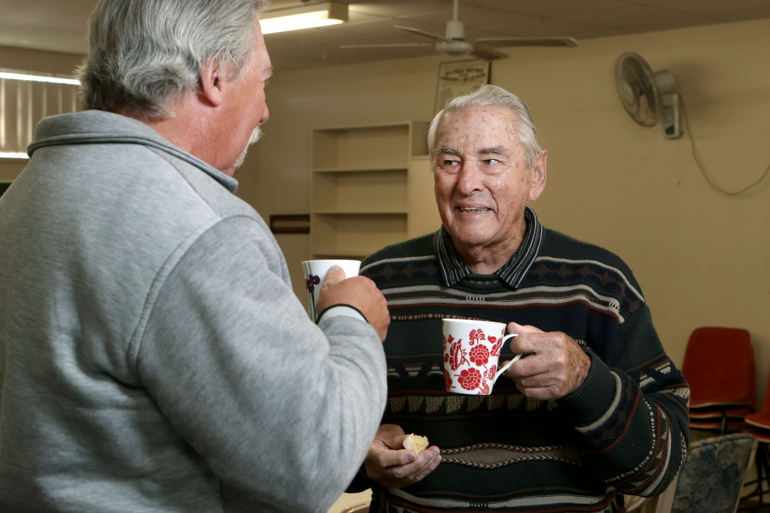 Older gentlemen enjoying a friendly tea time together.