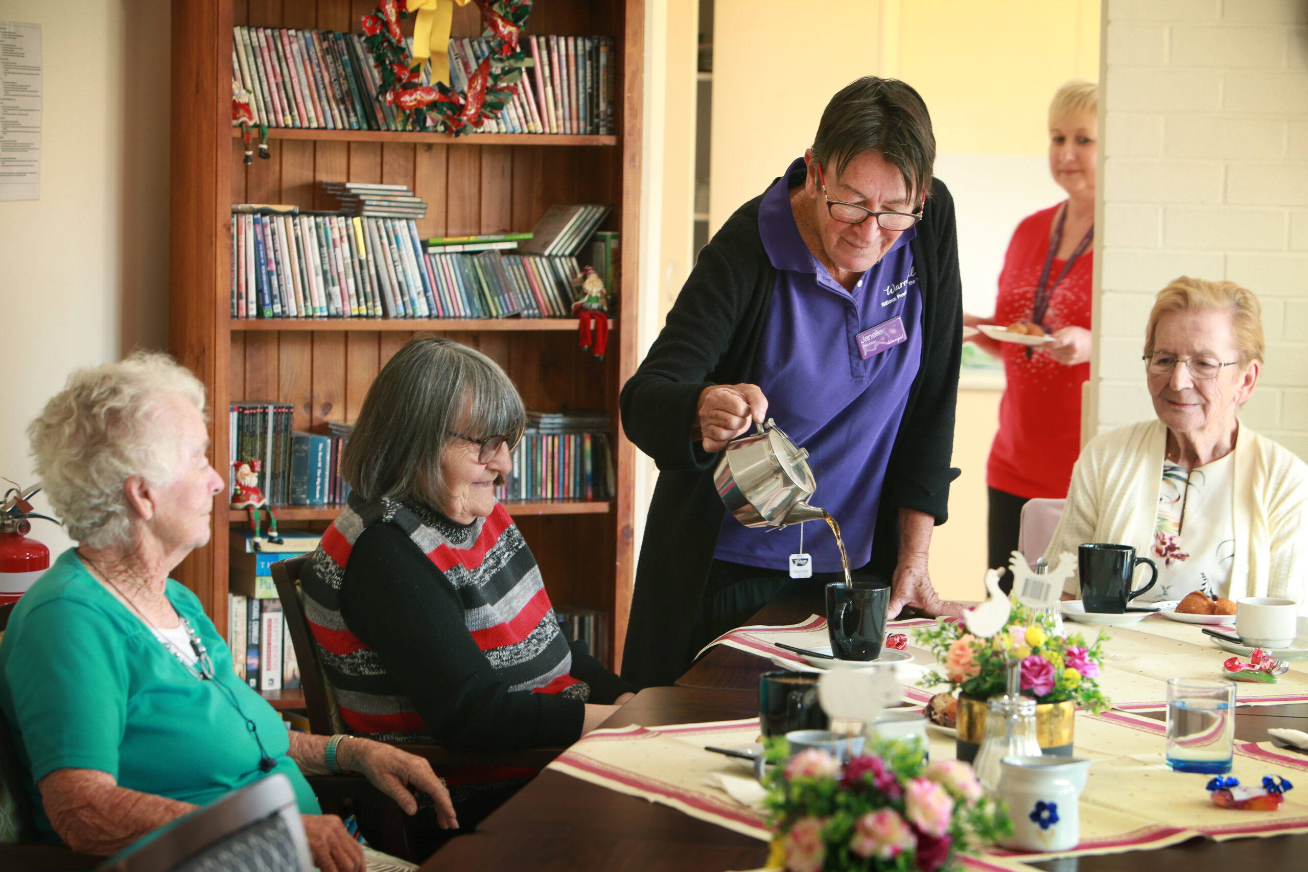 Warrigal residents socialising in a group, enjoying a friendly tea gathering.