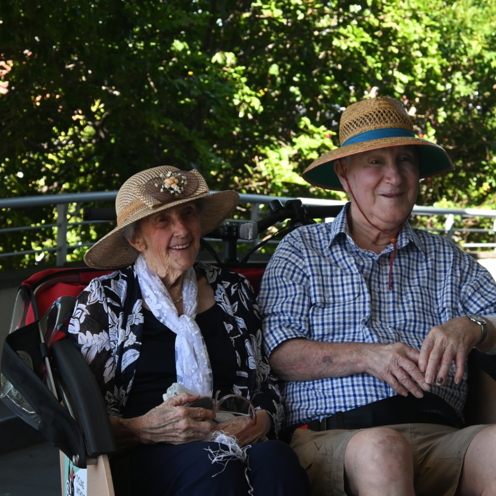 Smiling residents on board trishaw bike at Warrigal Wollongong
