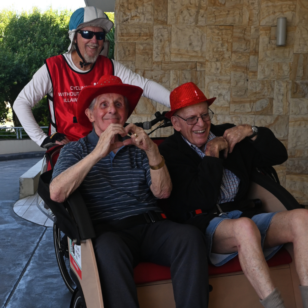 Smiling residents on board trishaw bike at Warrigal Wollongong