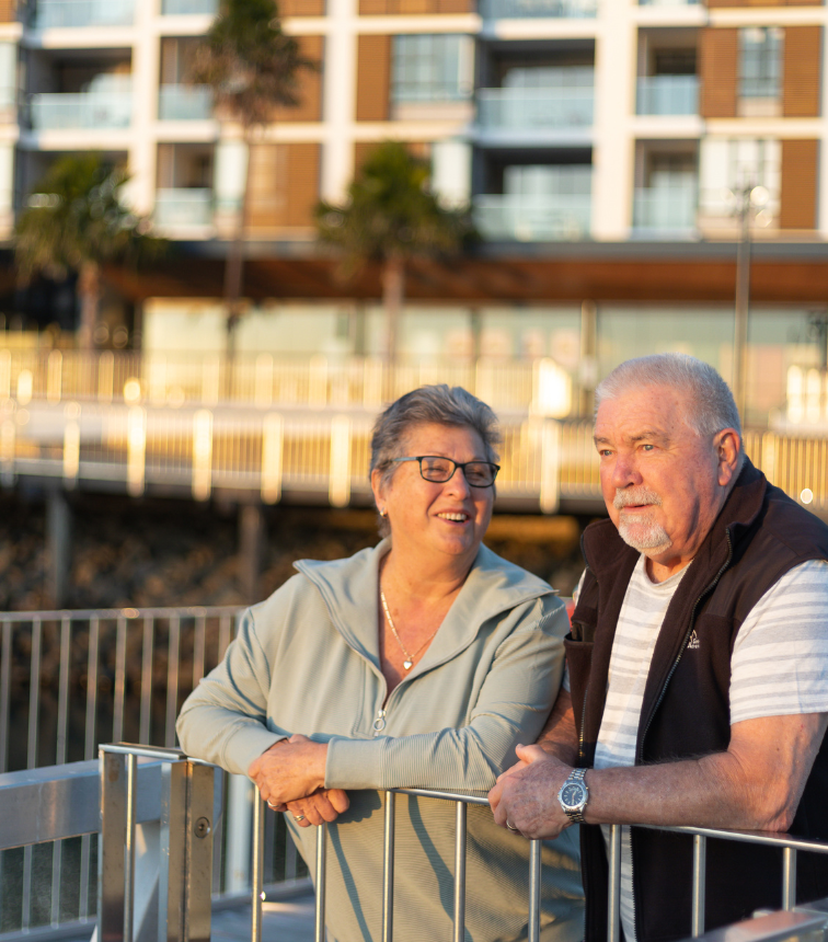 Two Shell Cove villagers smile as they look out into the marina.